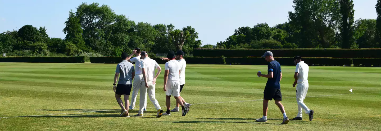 Students walking onto cricket pitch