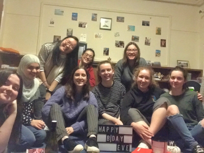 Belinda and a group of friends celebrating a birthday in a student room in Christ's College, Cambridge.