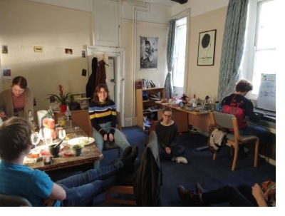 Clara having lunch with a group of friends in a First Court student room at Christ's College, Cambridge.