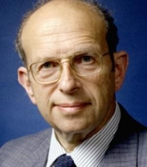 A person wearing glasses and a grey suit