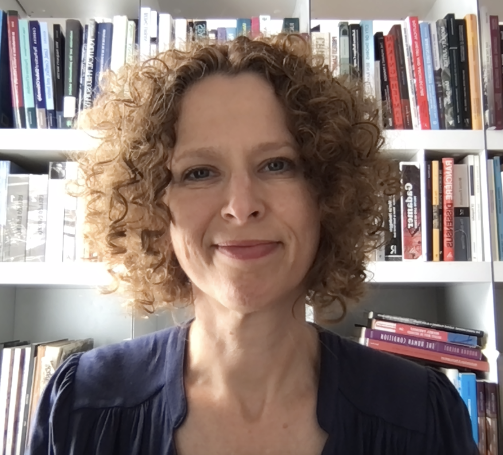 Irit Katz headshot in front of bookshelves