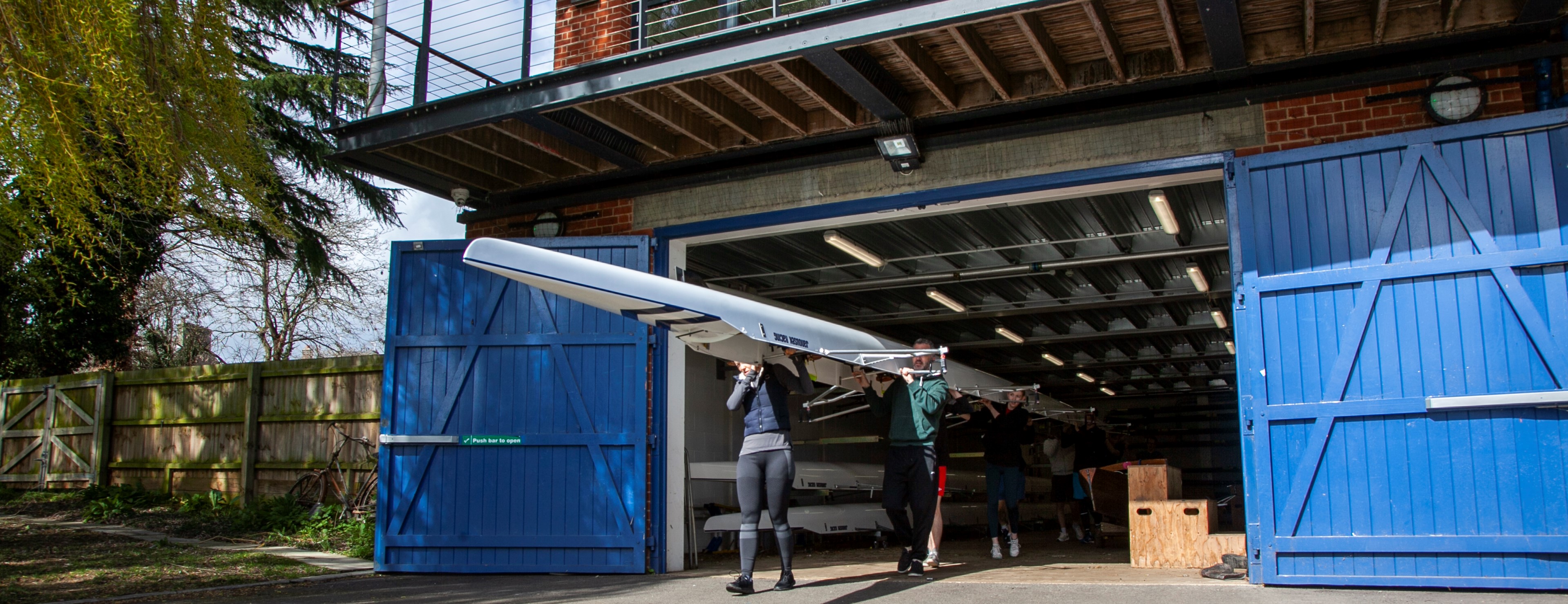 Boat being carried out of the boathouse