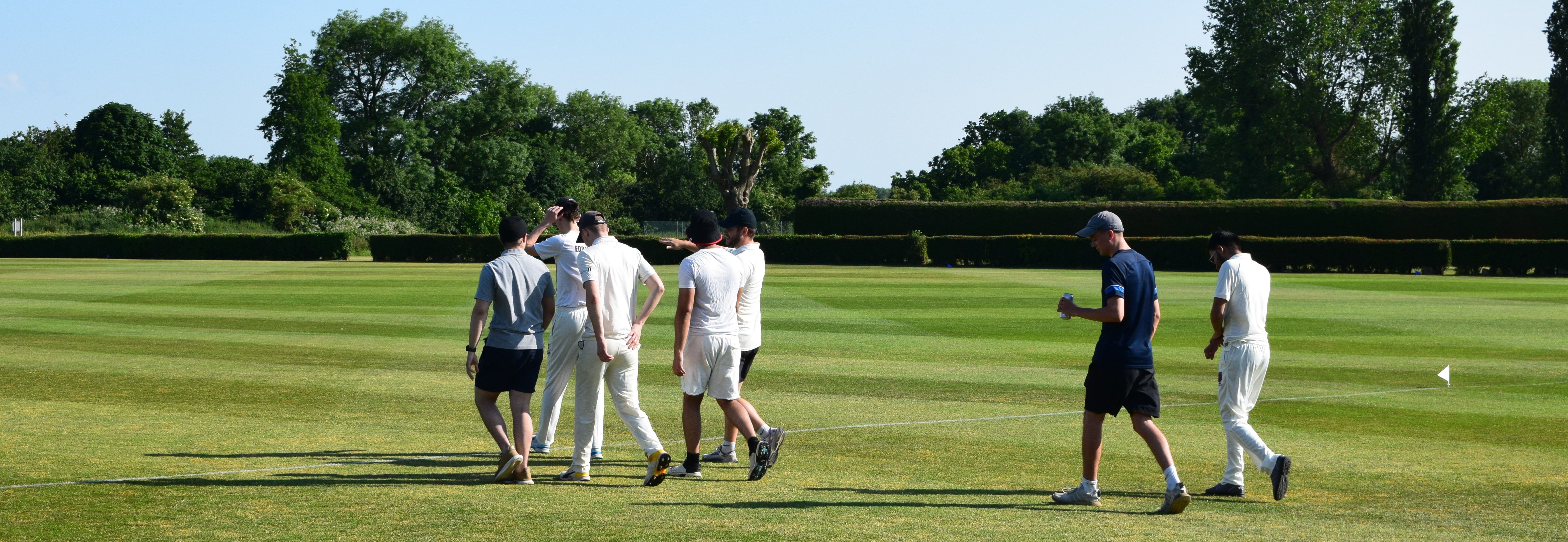 Students walking onto cricket pitch