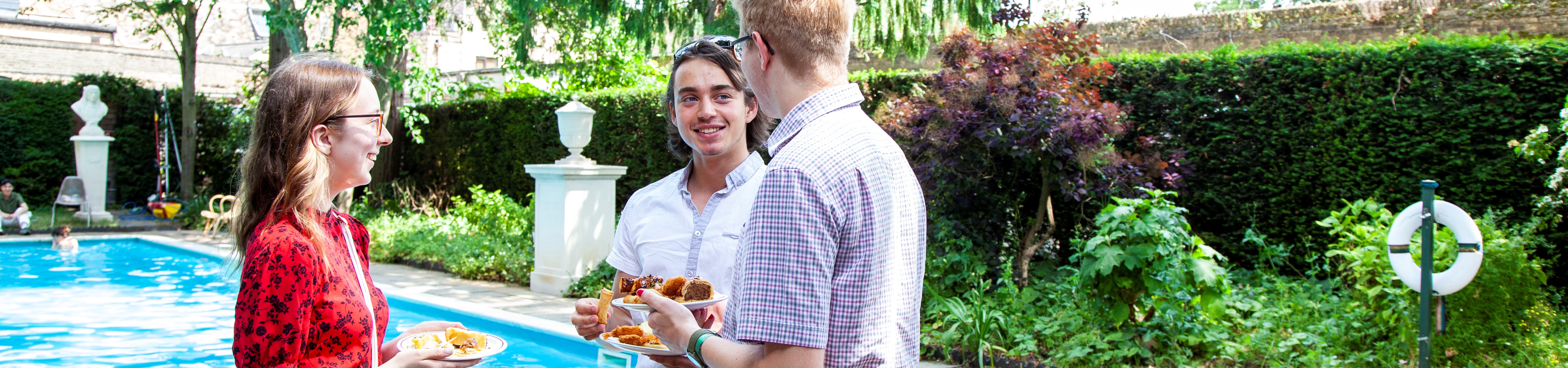 Students enjoying buffet by the swimming pool