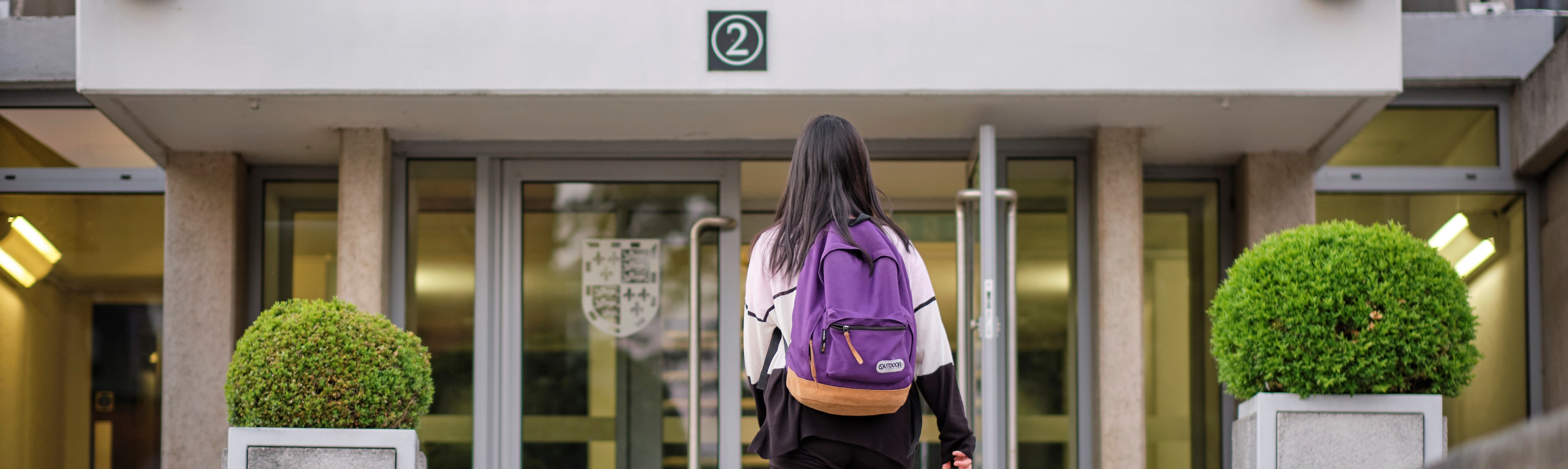 Student walking towards staircase 2 entrance