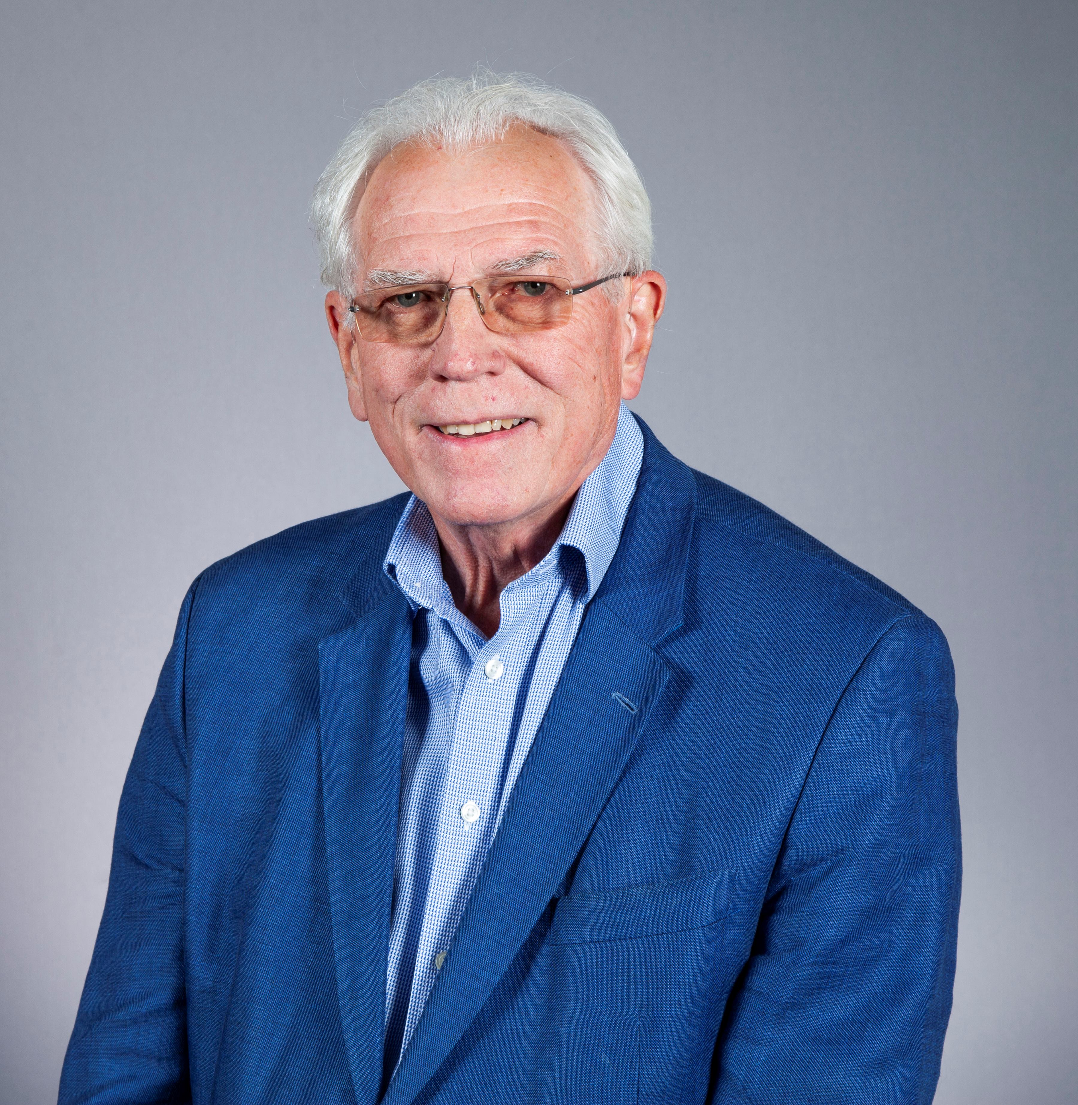 Smiling person in bright blue jacket