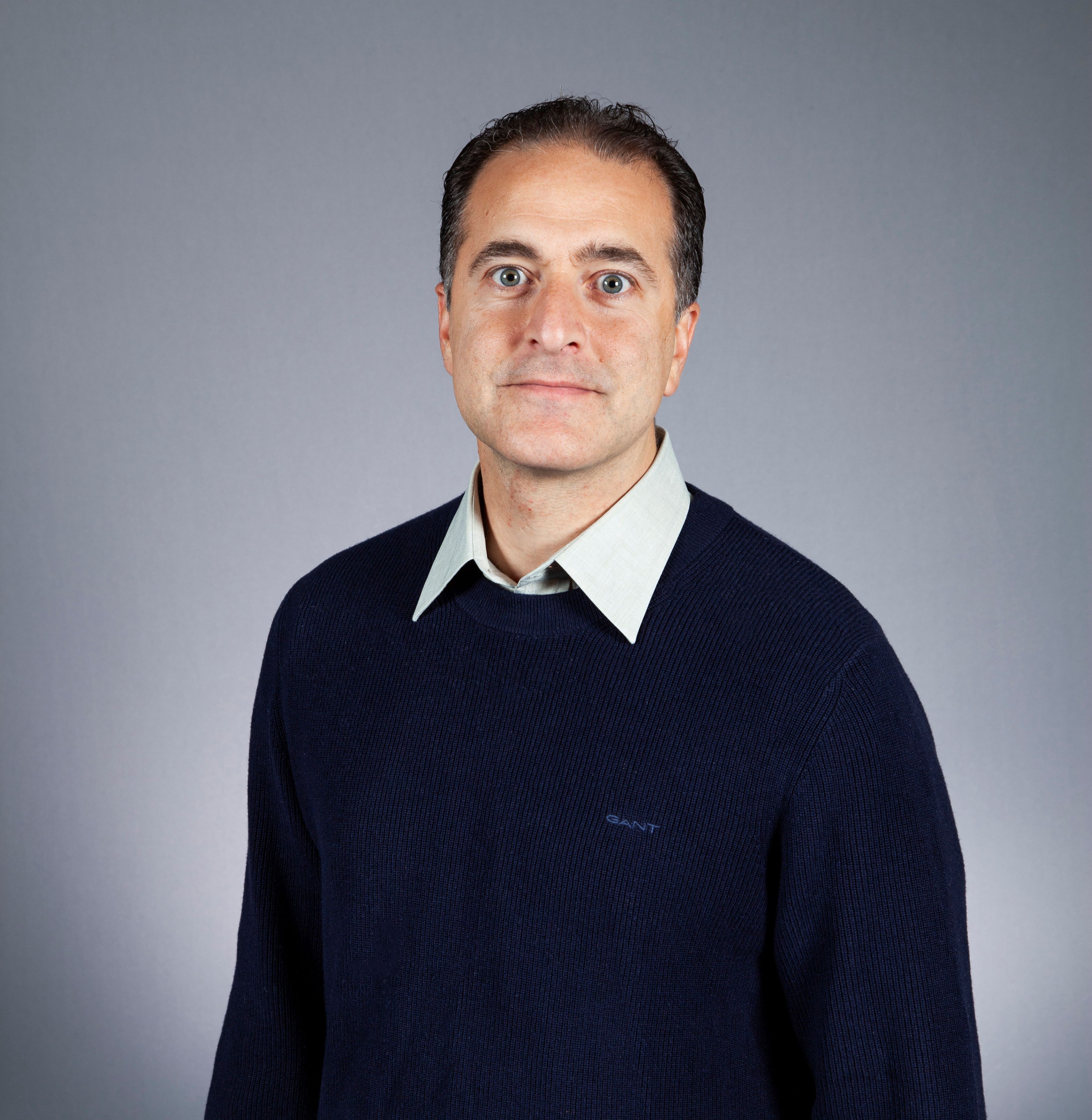 Smiling person in shirt and jumper