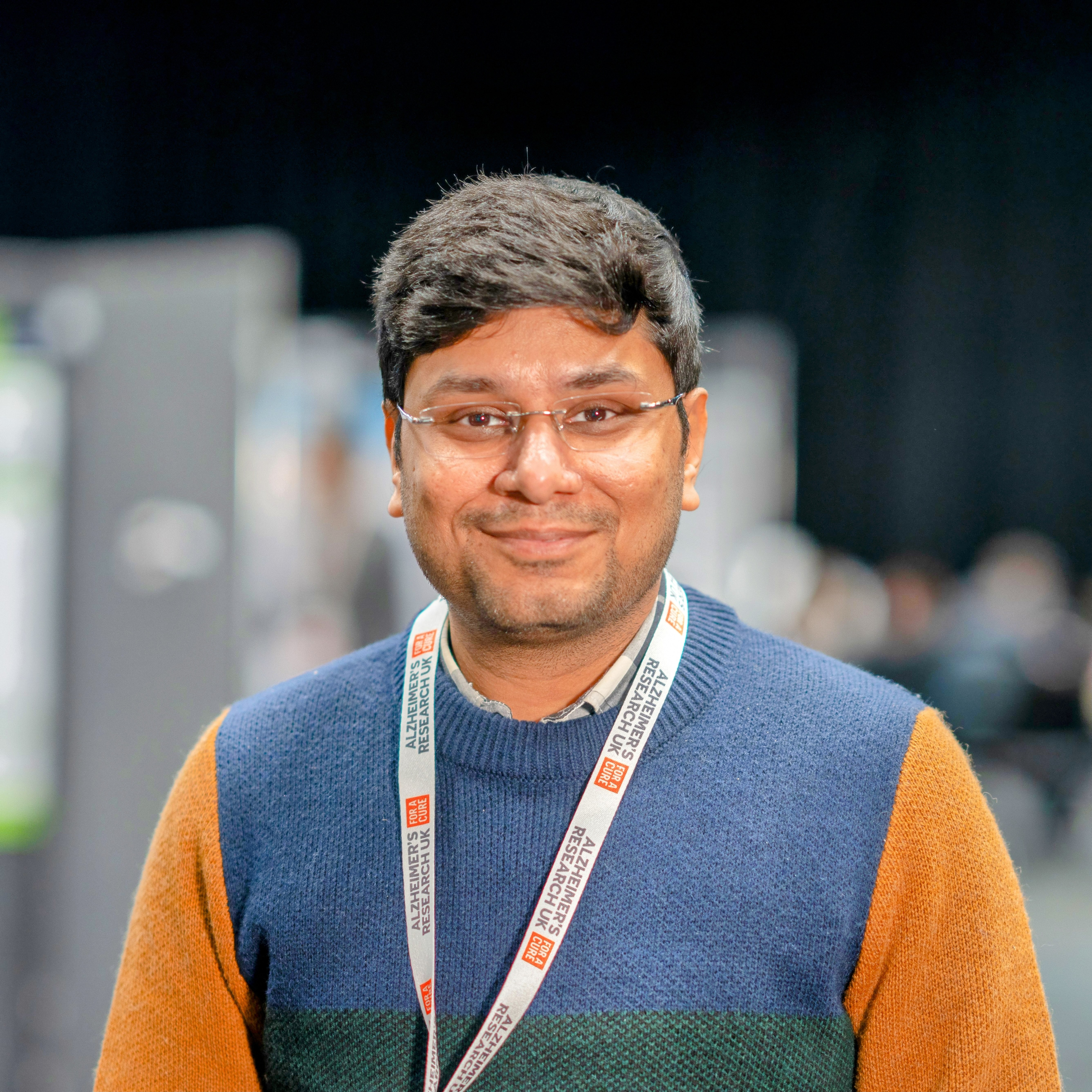 Smiling person wearing a lanyard