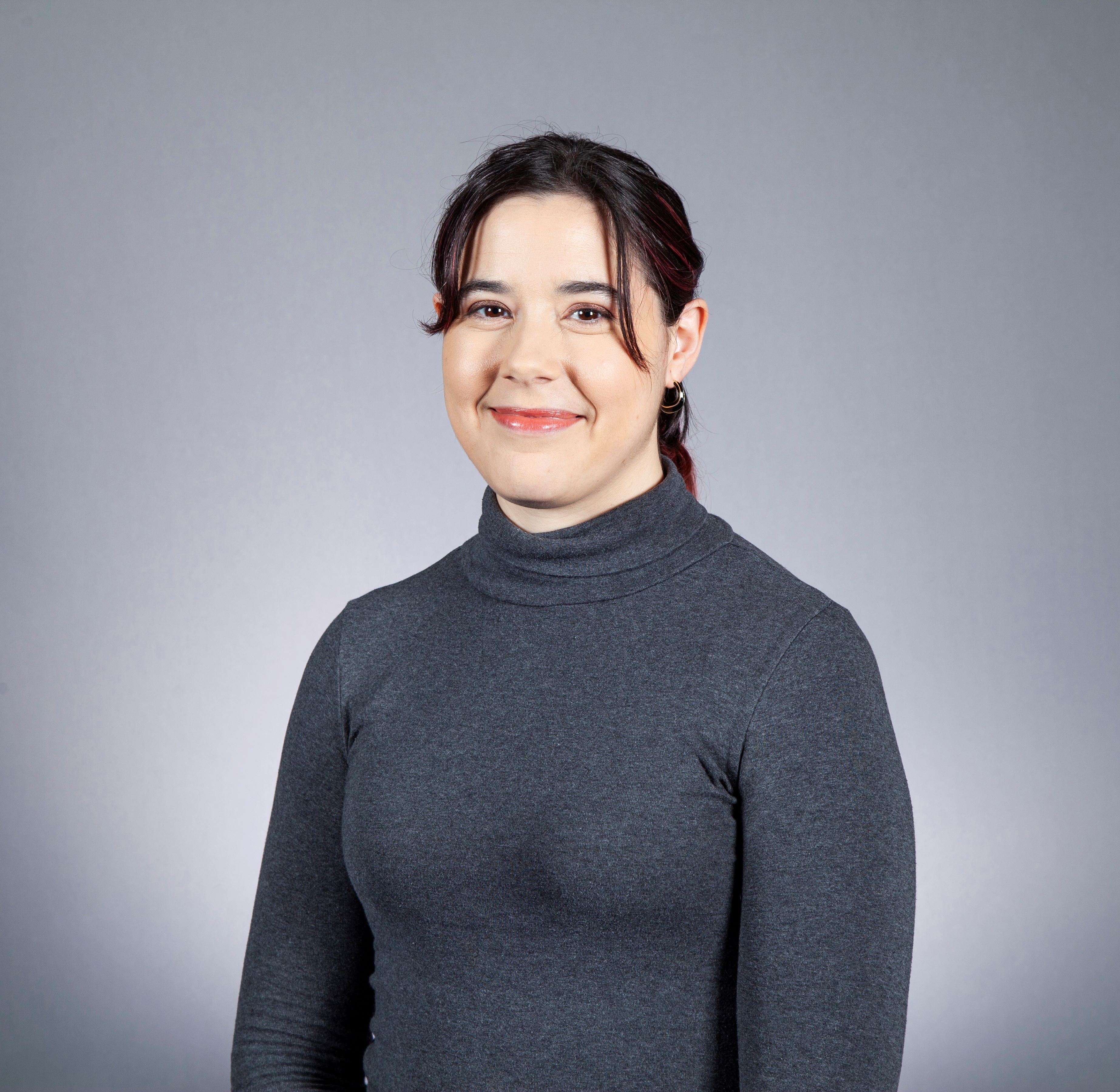 Smiling person in dark grey jumper