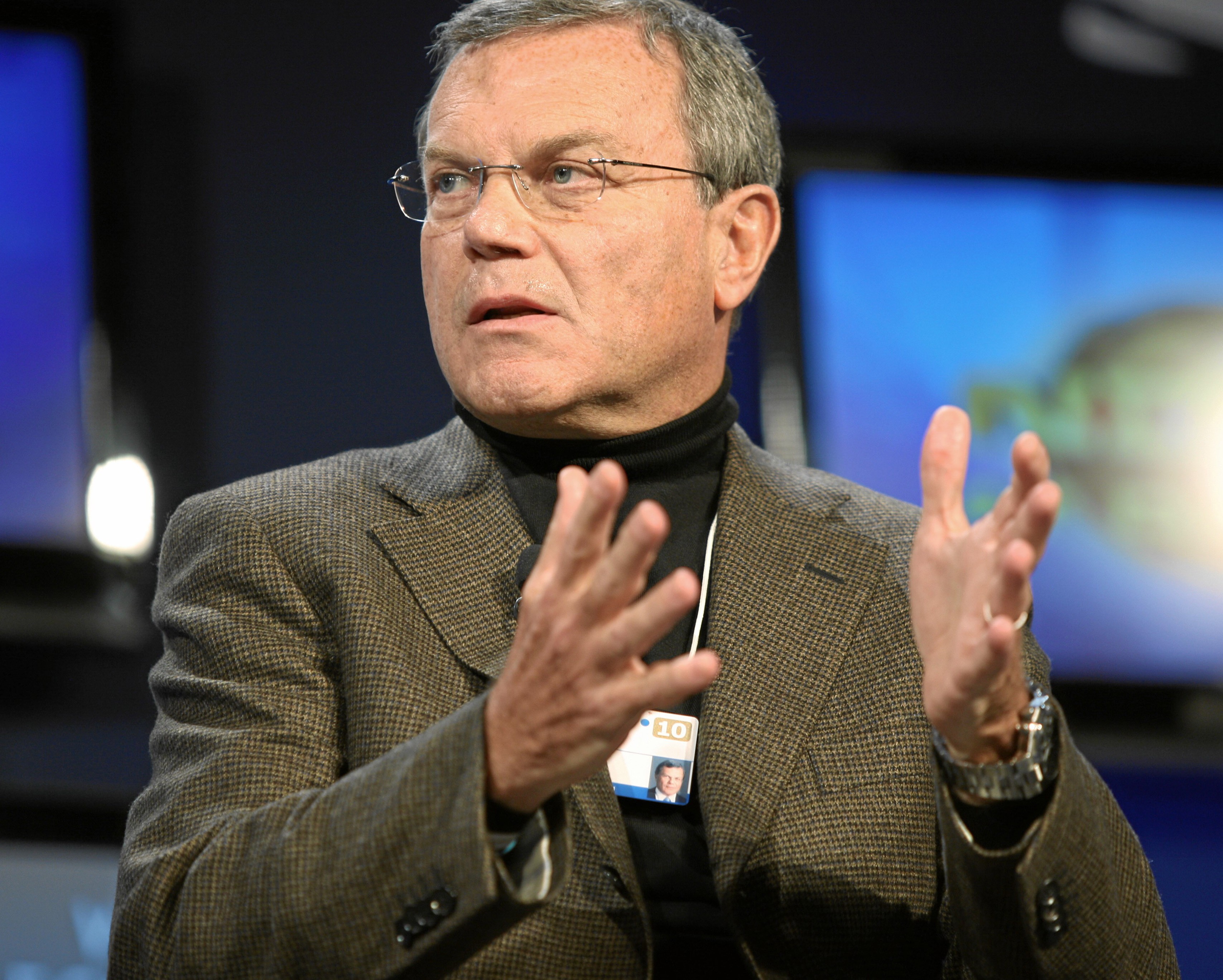 Martin Sorrell speaking, his hands held up 