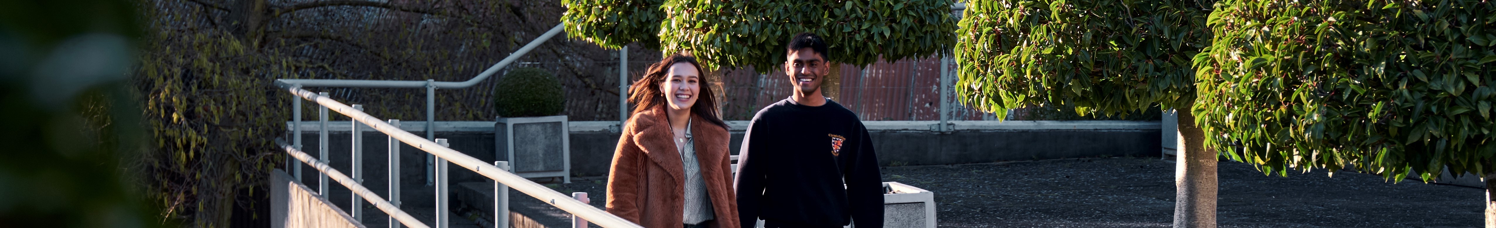 Two students walking in New Court