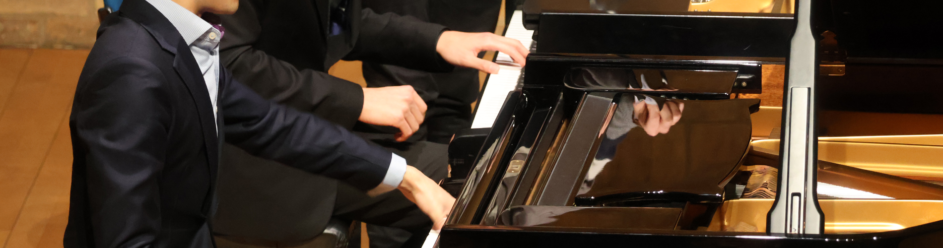 Hands on a piano keyboard