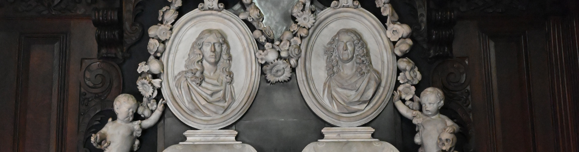 Detail of two portraits on the Finch and Baines memorial