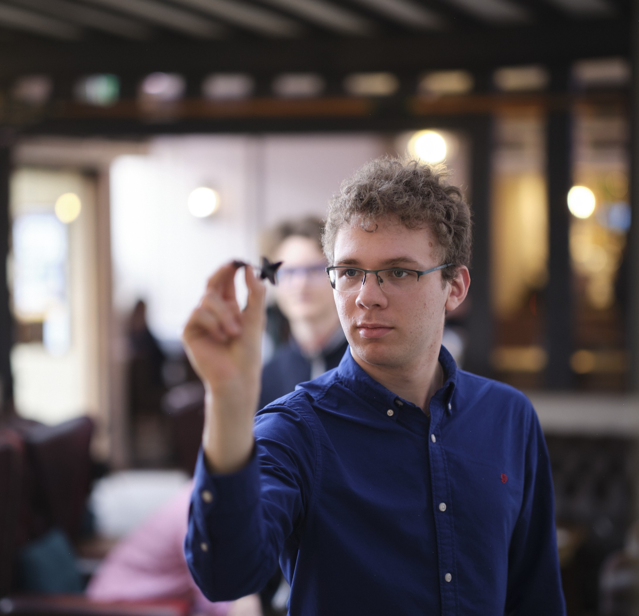 Student playing darts in the Buttery