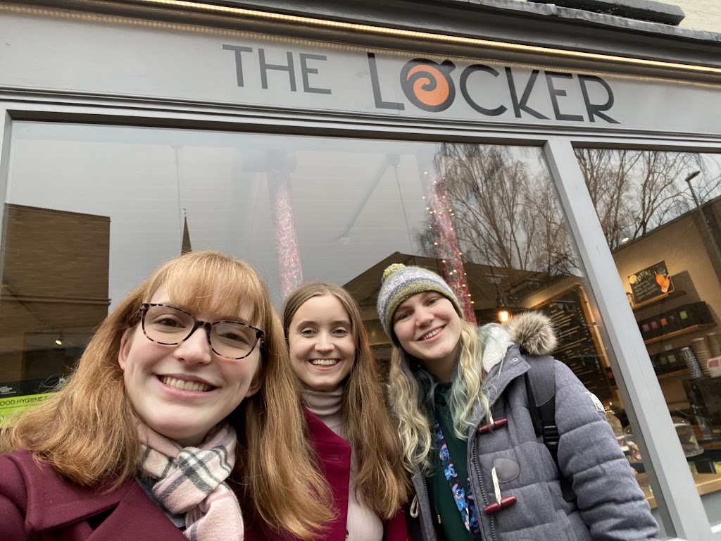 Selfie of three friends outside a cafe