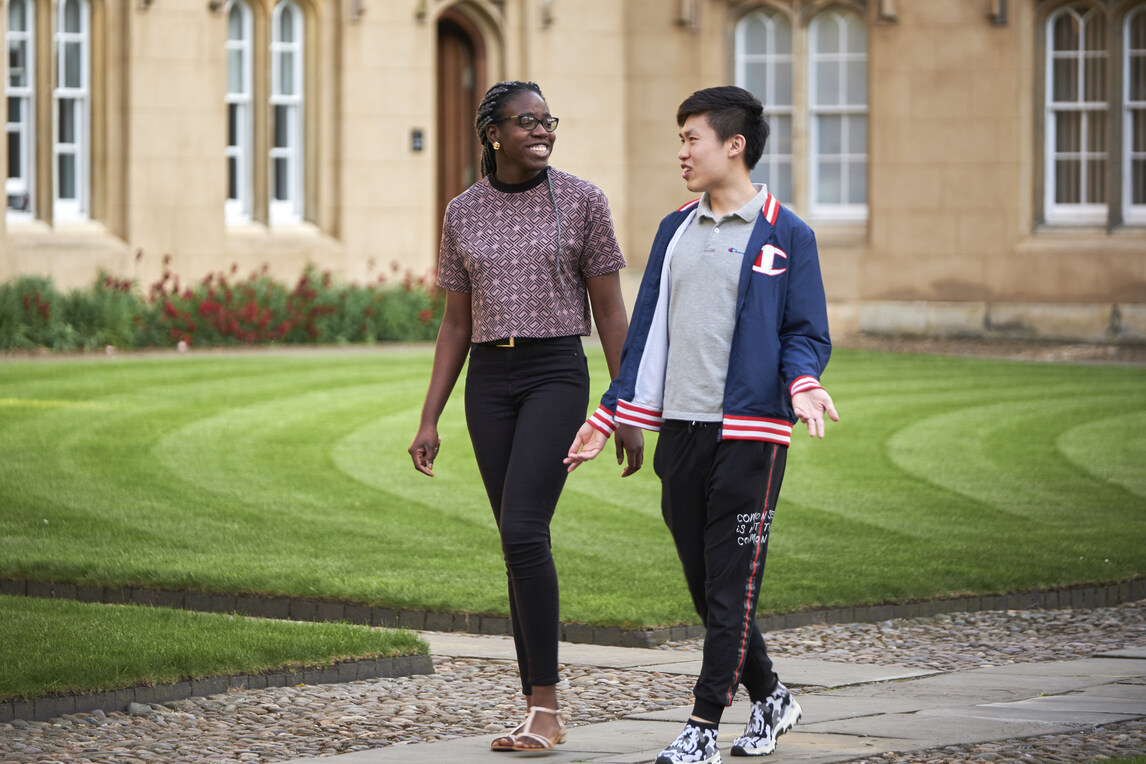 Students walking through second court, talking