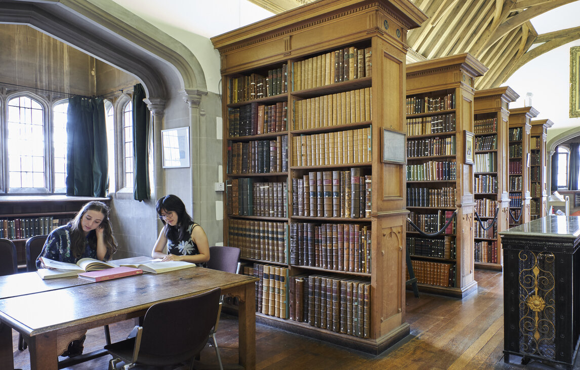 Students looking at books in the Old Library