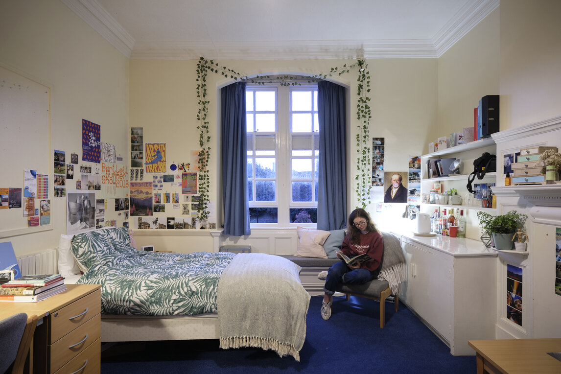 A student reading in their room