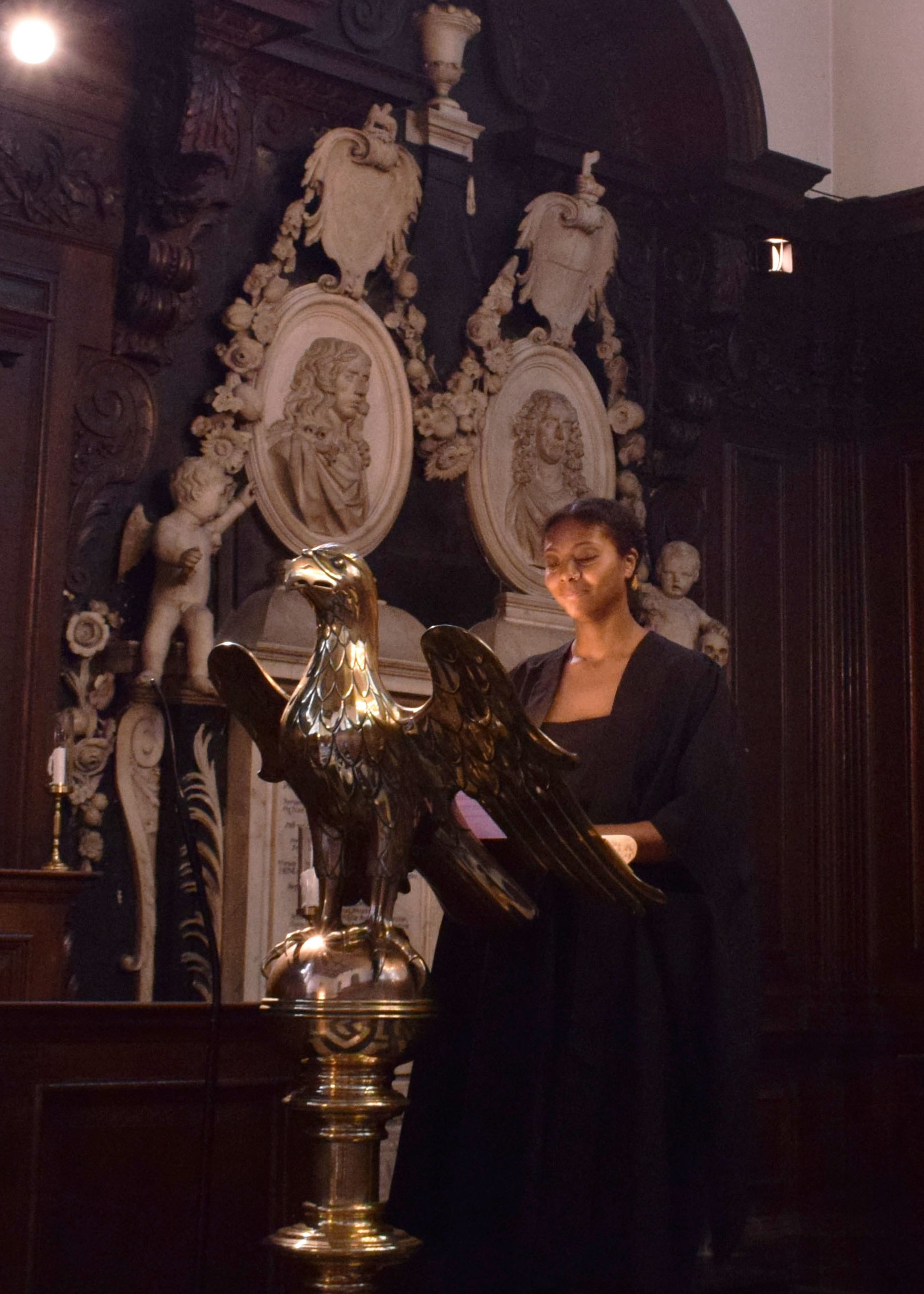 Woman reading a lesson at a brass lectern