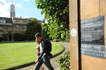 Two students walking past G staircase