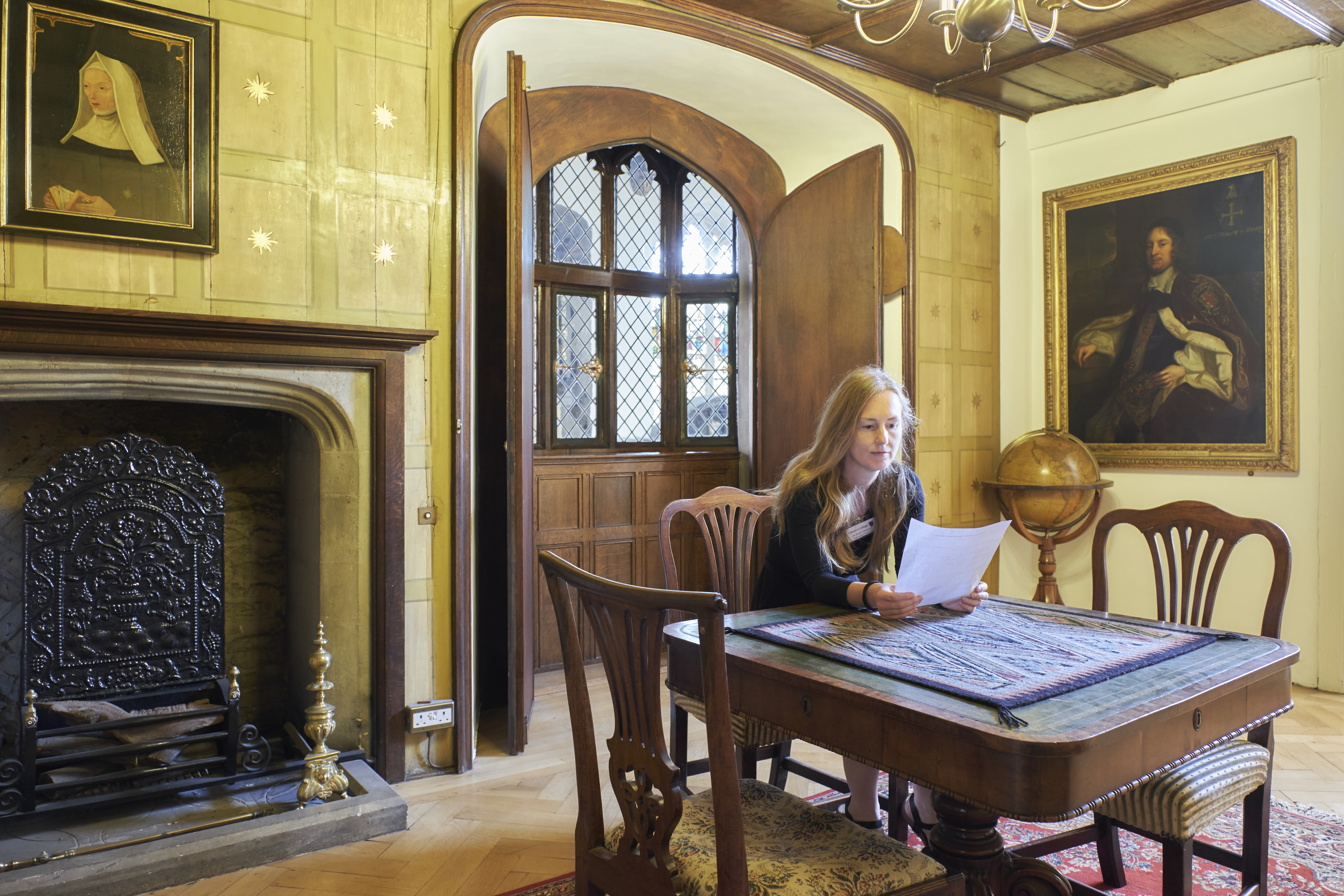 Dr Tomlinson at table, reading