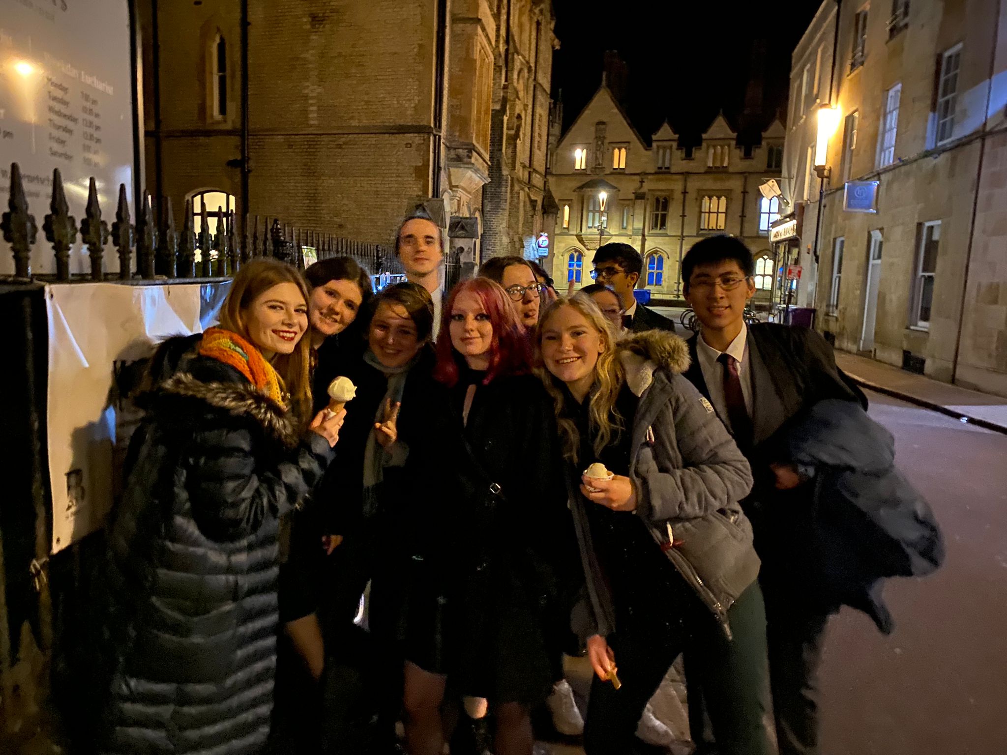 A large group of friends, eating ice cream and smiling. Oliwia is at the front on the left