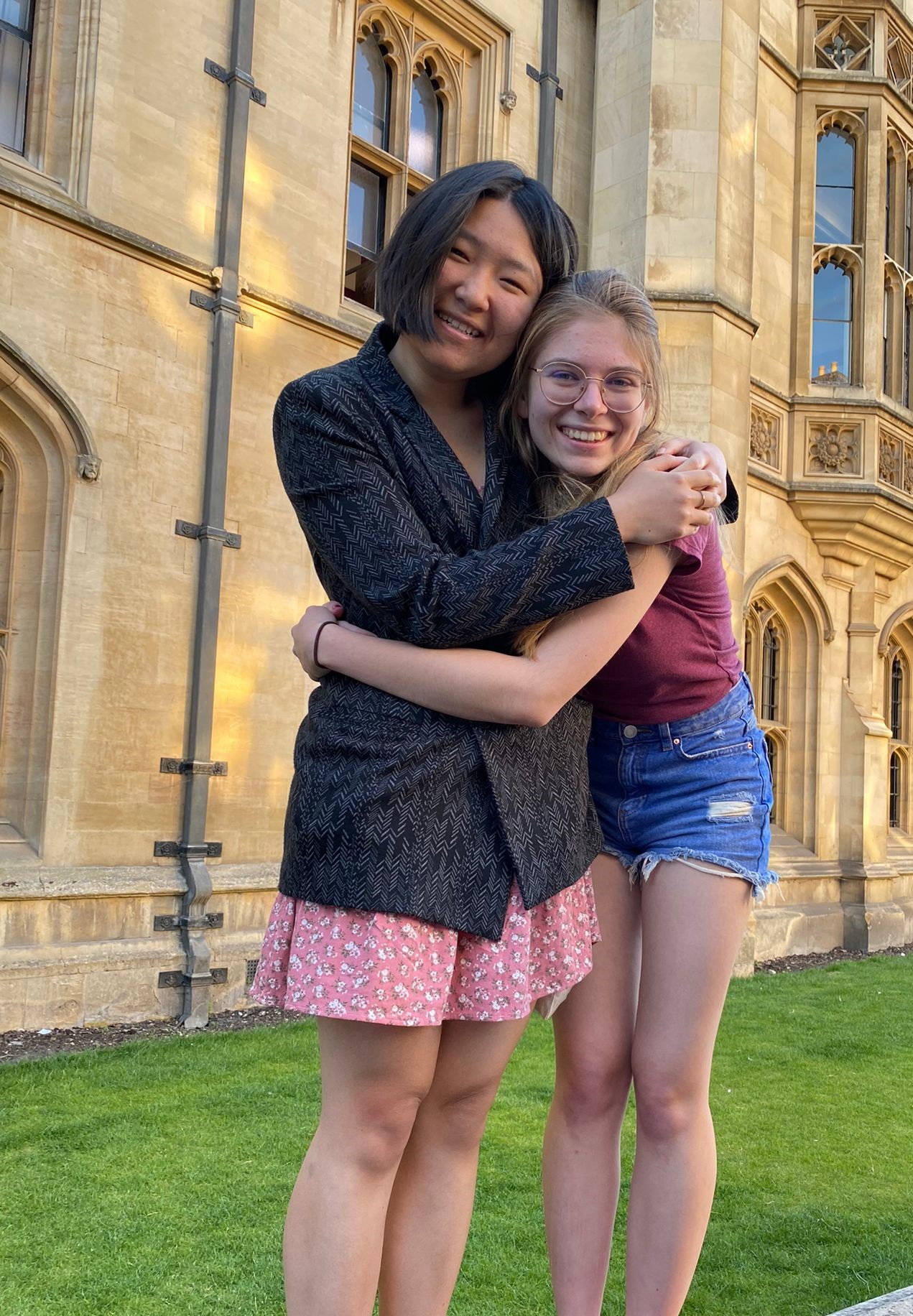 Two students hugging in front of King's College
