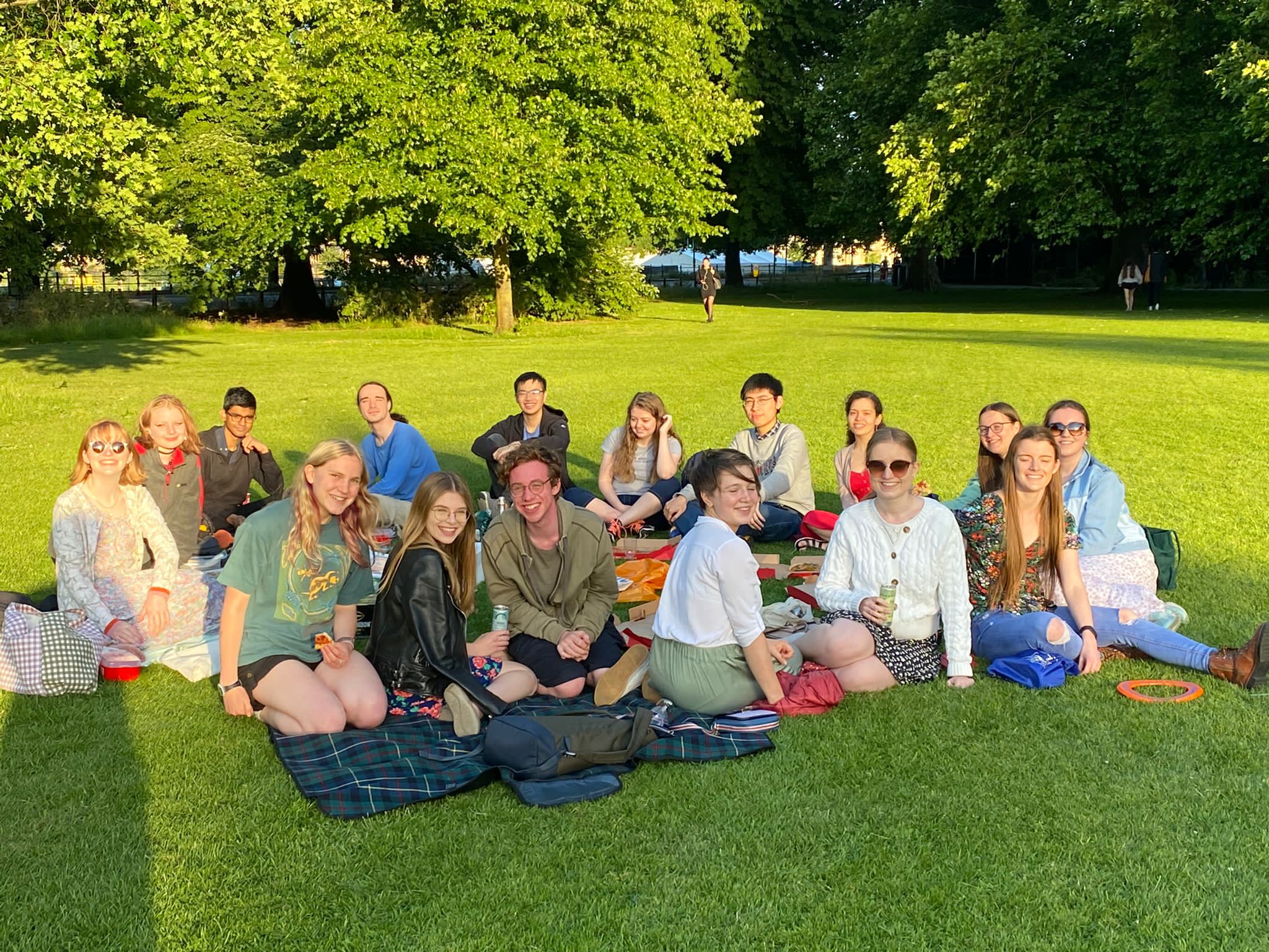Big group of students, sat having a picnic