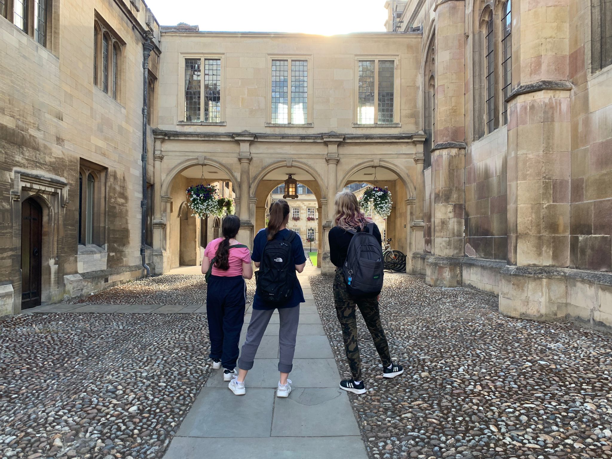 Three students from the back, looking at an archway