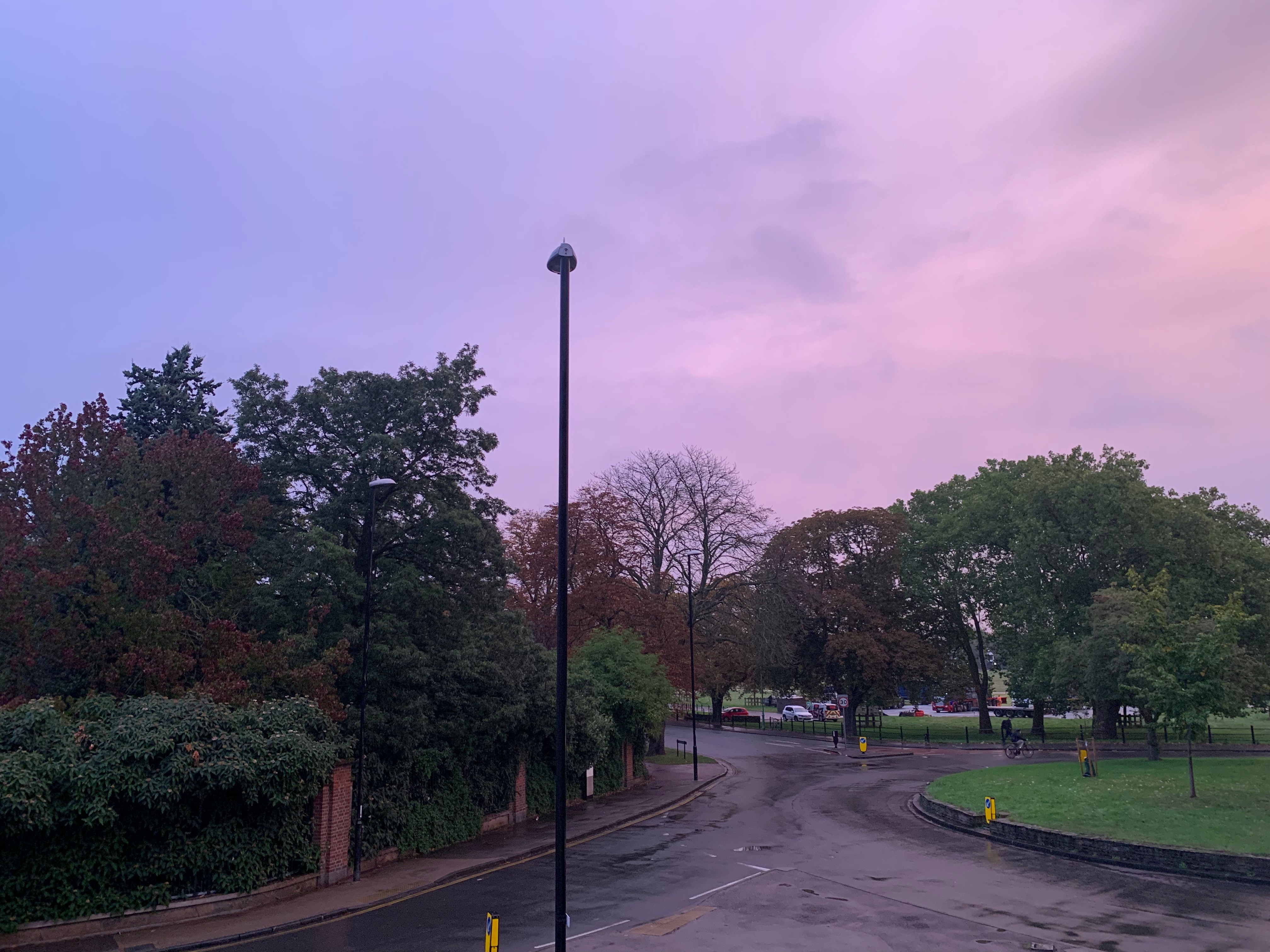 Roundabout with a park in the background, at sunset