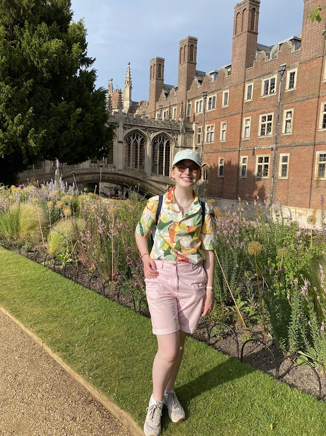 Sophie, with Cambridge scenery and flowers in the background