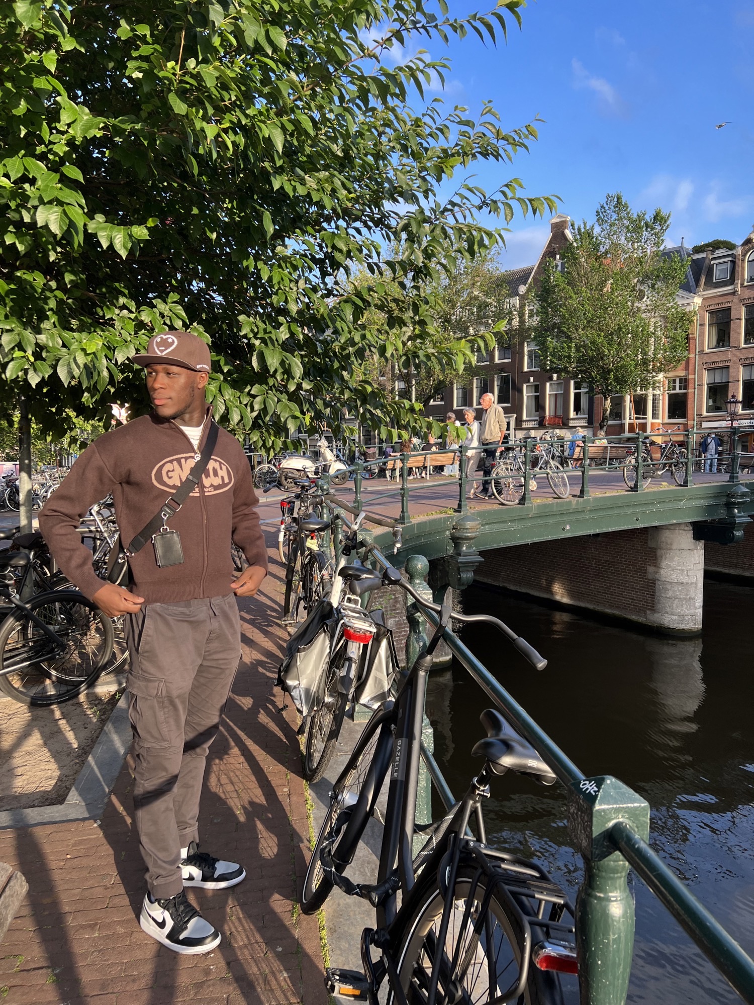 Ayo stood in front of a bridge with bikes