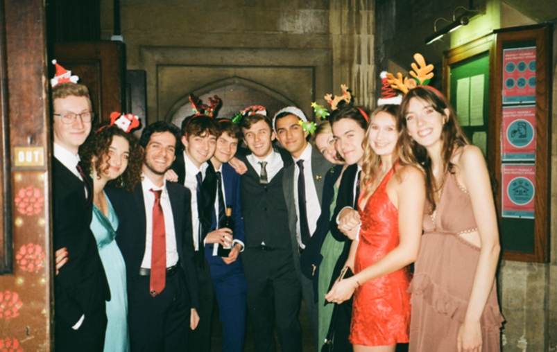 A group of friends with christmassy headwear and formal dress