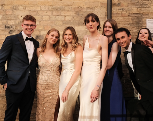 Seven students in black tie dress