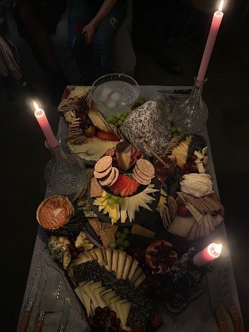 A display of cheese and snacks, with candles