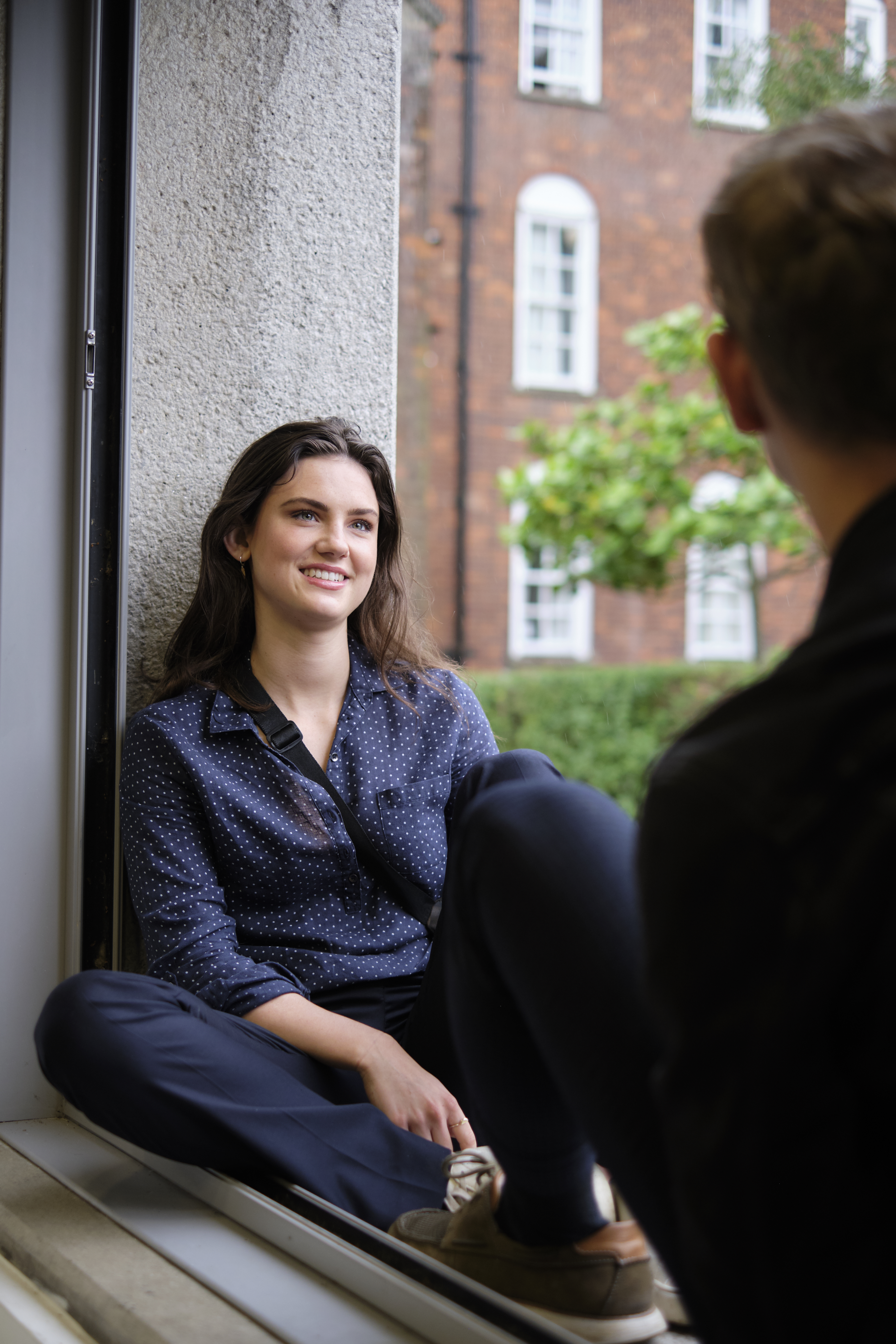 Students sitting in the common room window