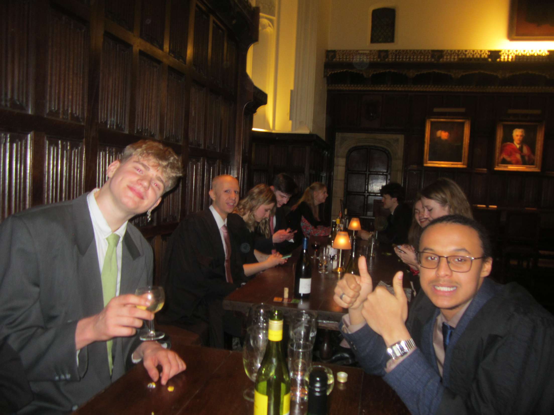 Students sat in Formal Hall. Elliott gives a thumbs up