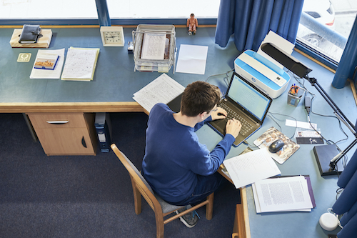 Student working at desk in New Court room