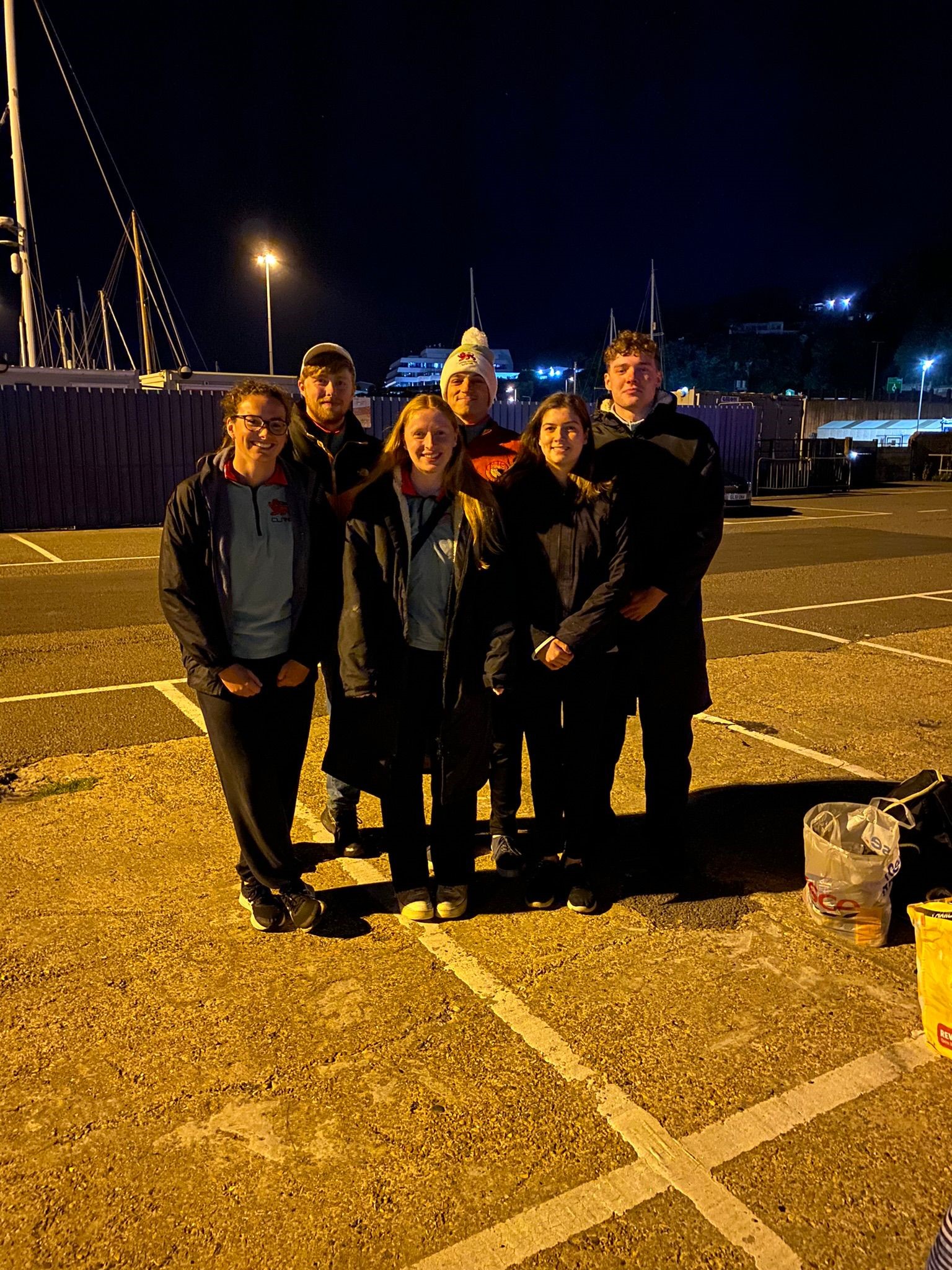 Six people standing at a port