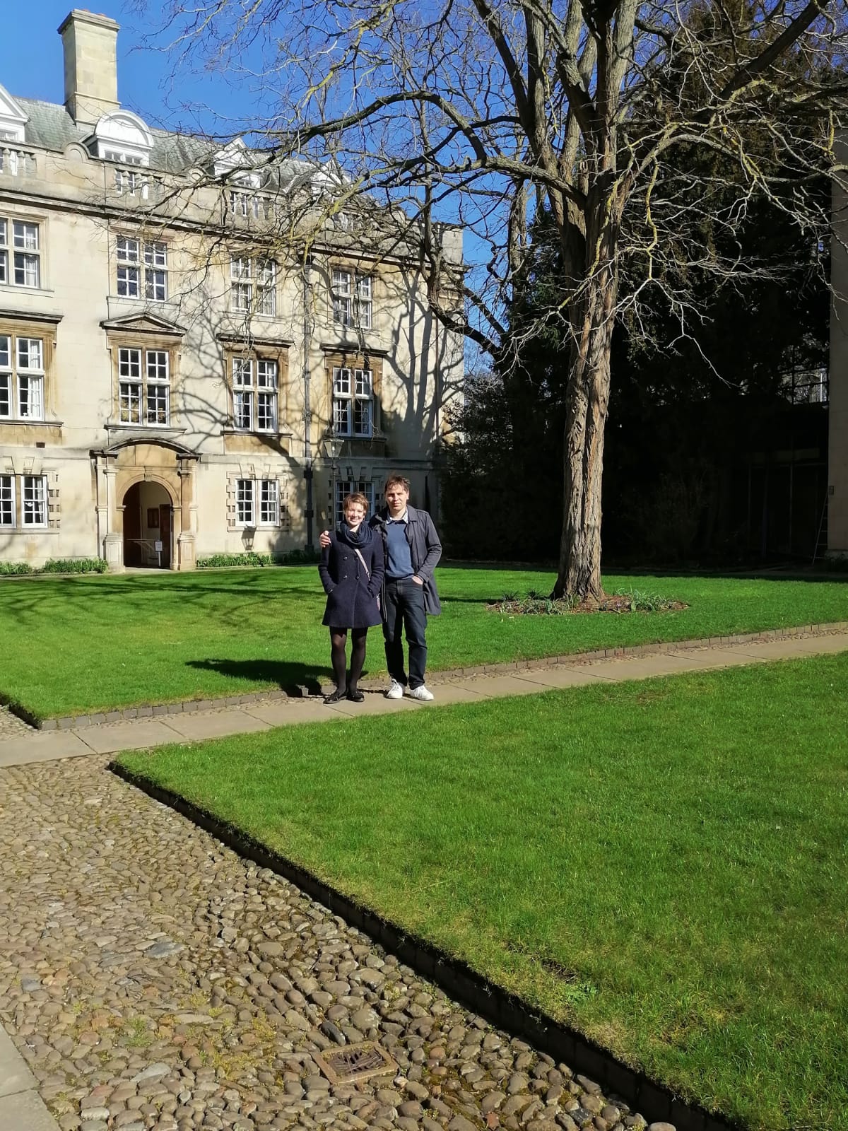 A student and their parent stood on a lawn in front of the Fellows' building in second court