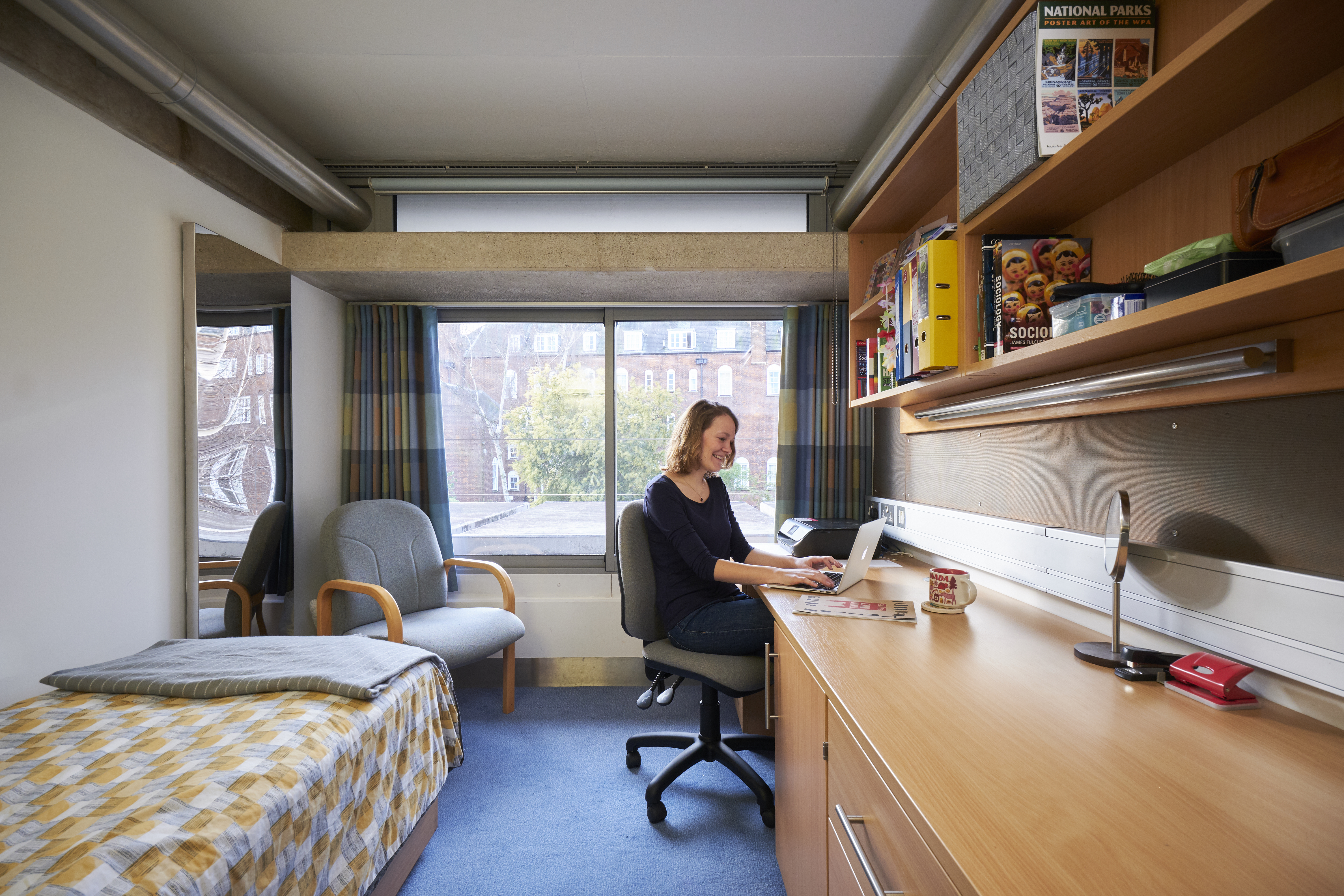 Student working at desk in New Court bedroom