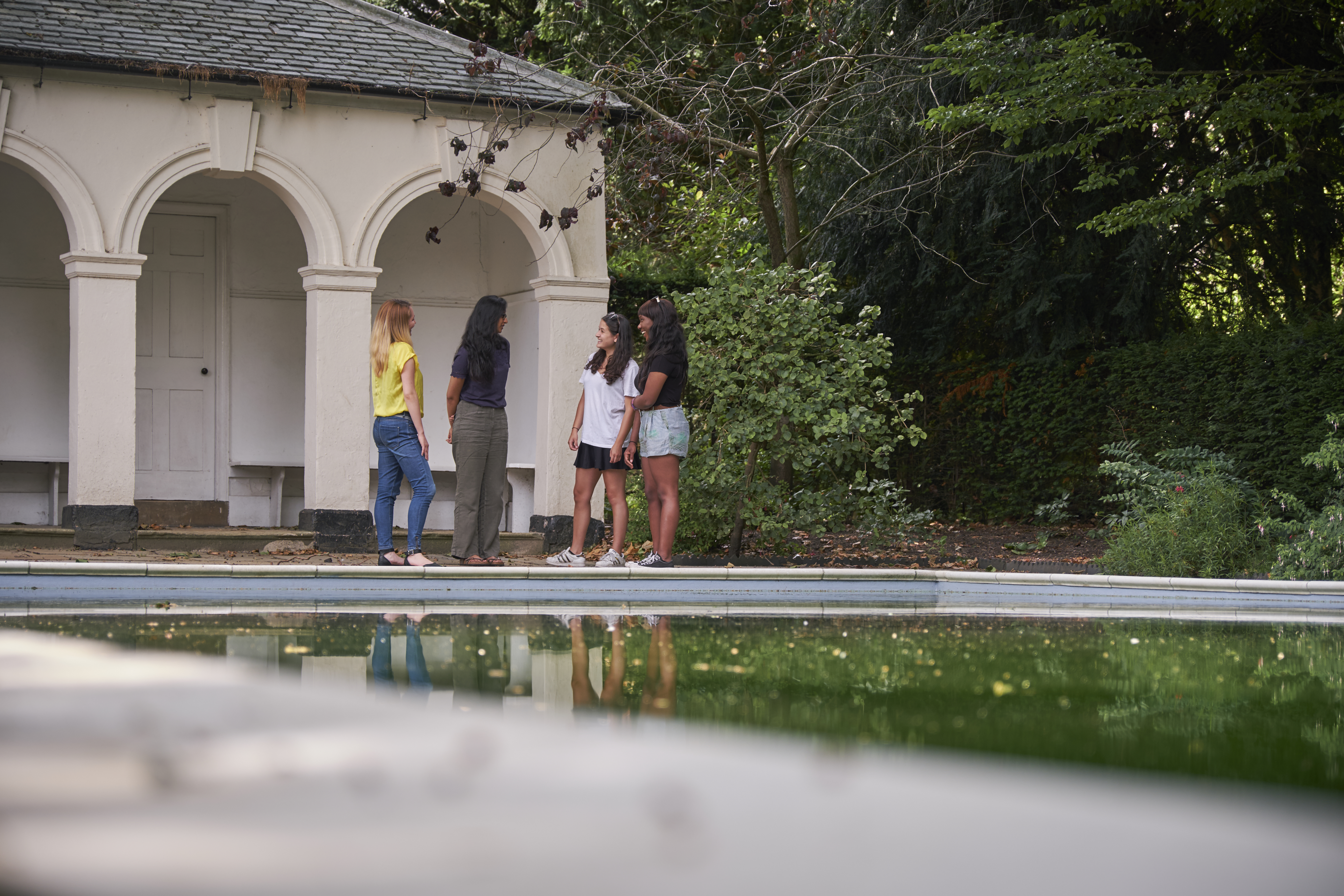 Students talking at swimming pool