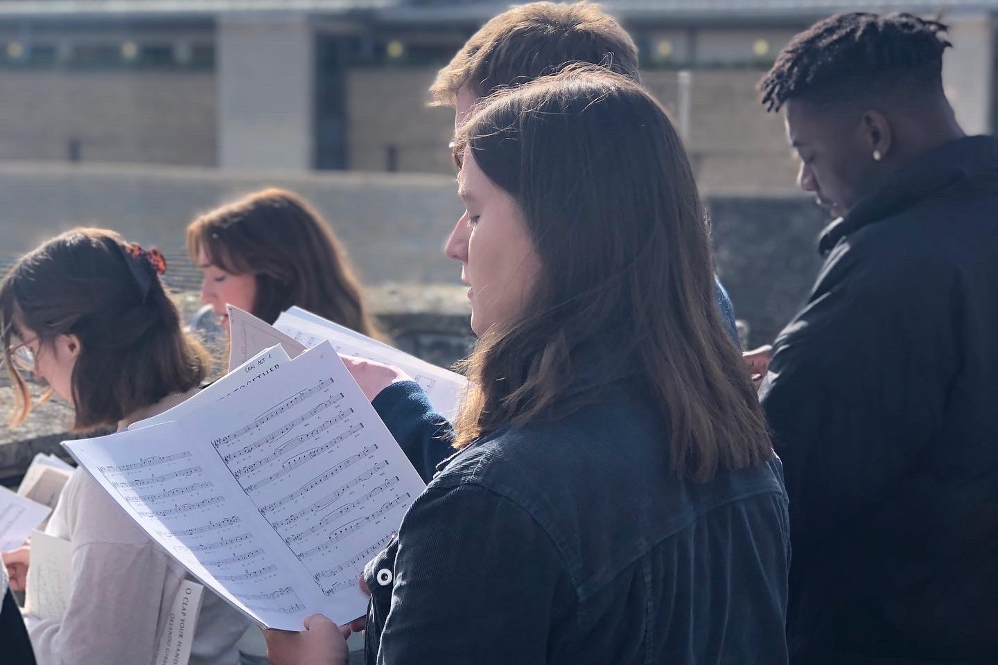 Students singing with sheet music