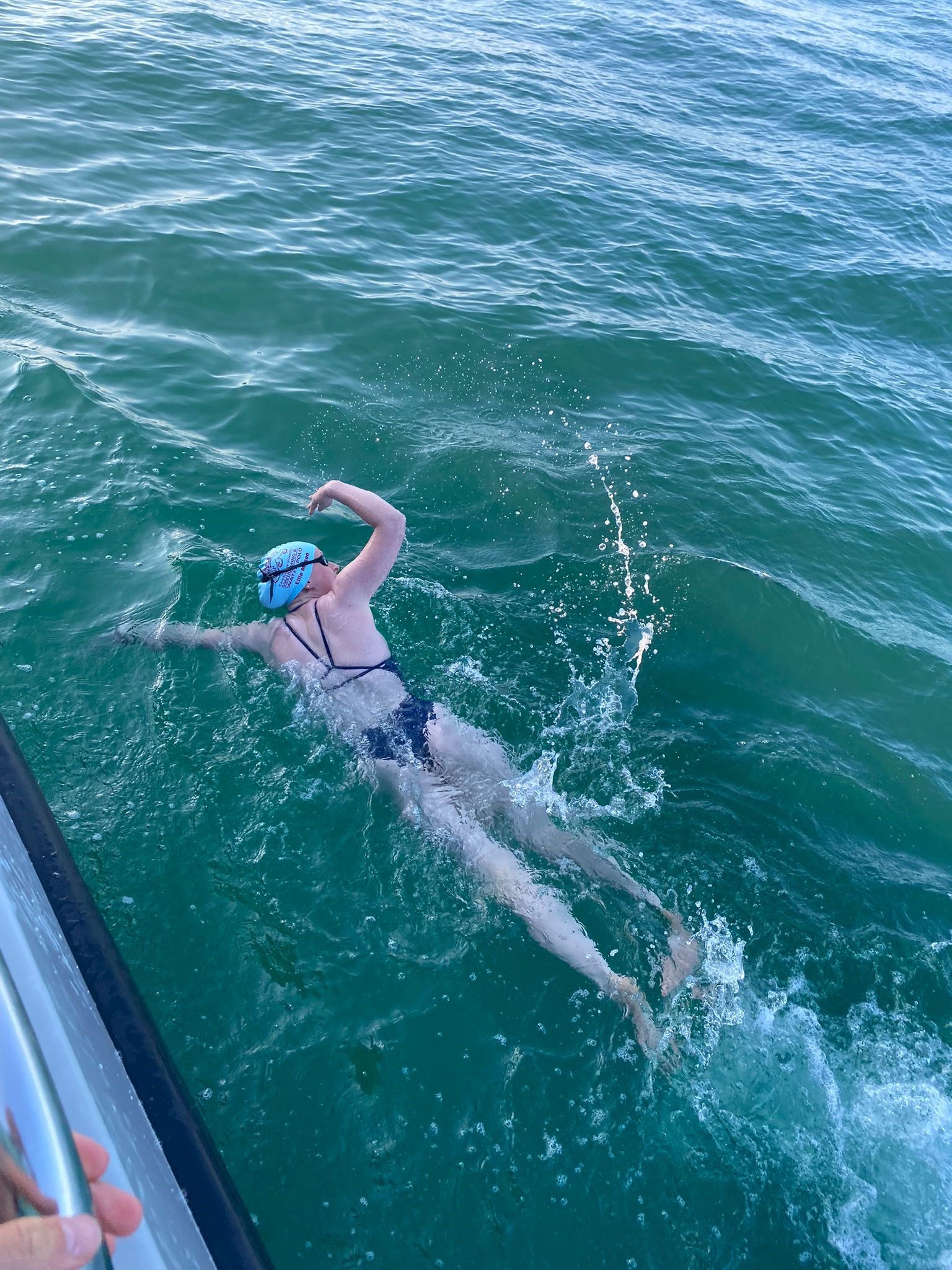 person swimming in channel