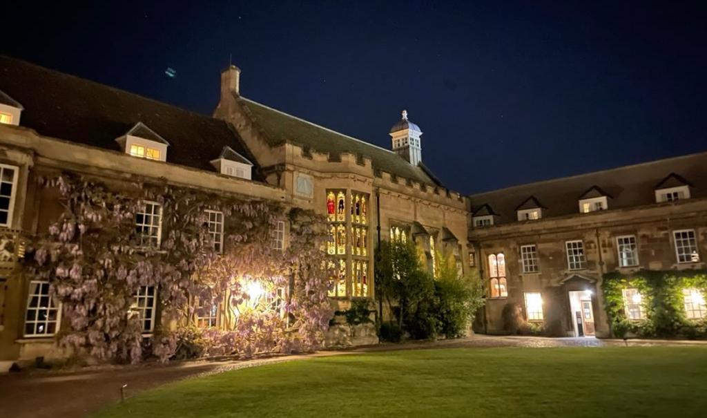 A shot of an old building in First Court at night, with ivy growing on the walls