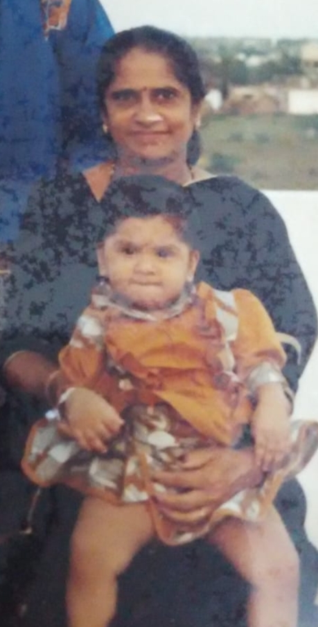 A little girl sitting on her grandmother's lap