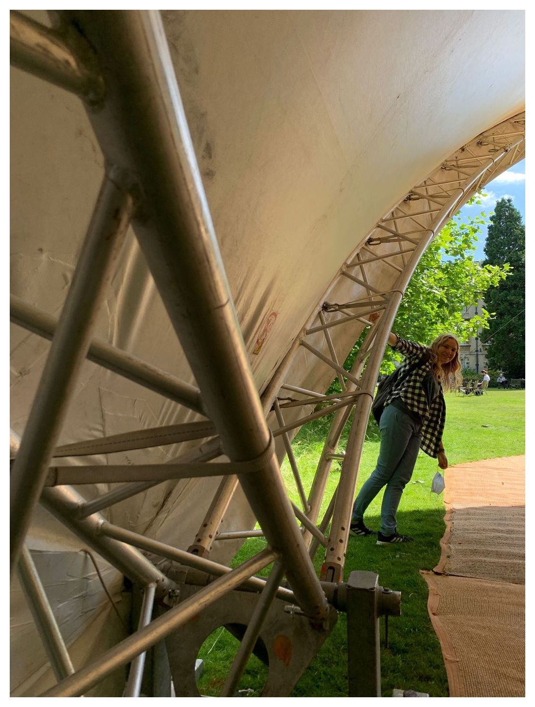 Romany holding onto a railing that makes part of a stage