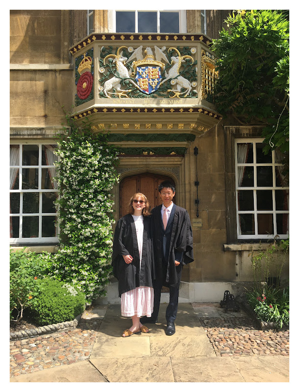 Two students stand in front of the gate to the Masters' Lodge