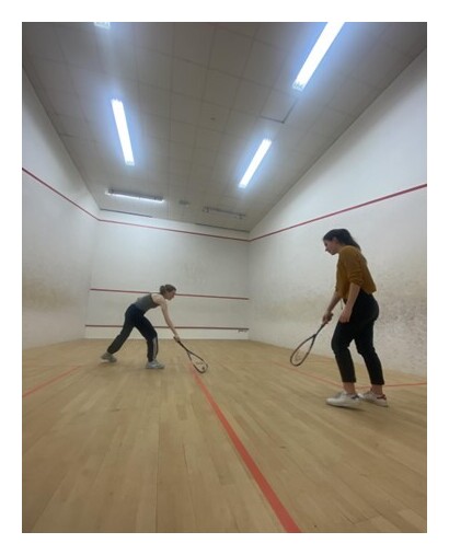 Two students playing squash