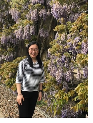 Belinda standing in front of the wysteria covering the front of the Master's House in First Court at Christ's College, Cambridge.